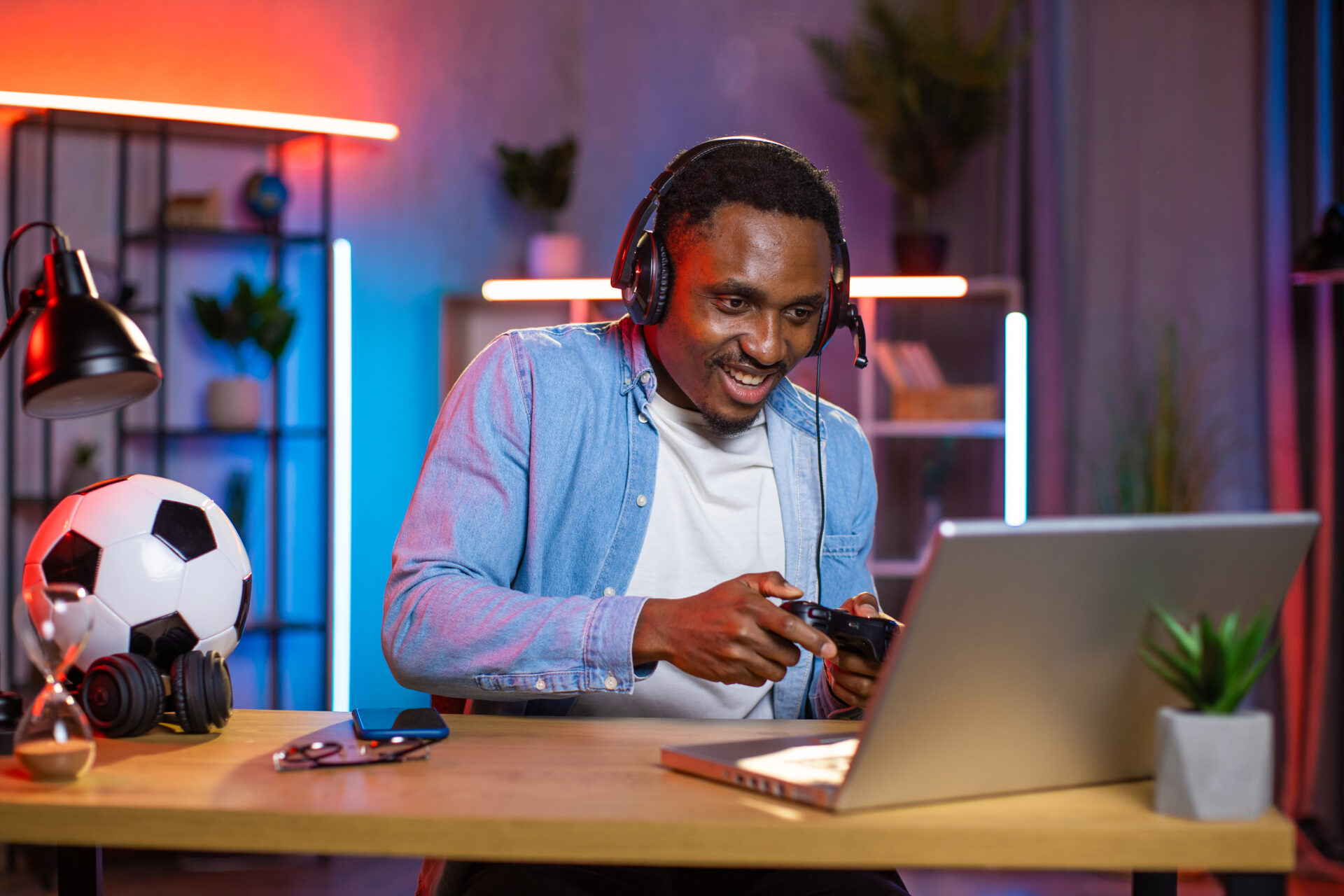 excited-black-man-in-headset-playing-video-games